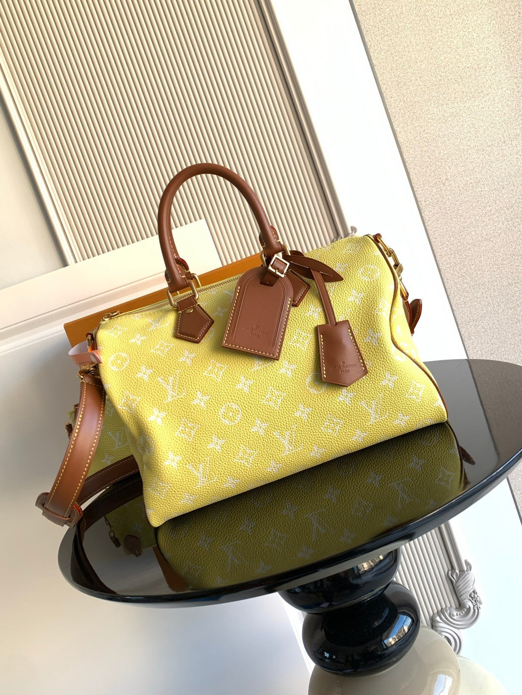 Louis Vuitton bag in yellow monogram with brown leather top handles and tags