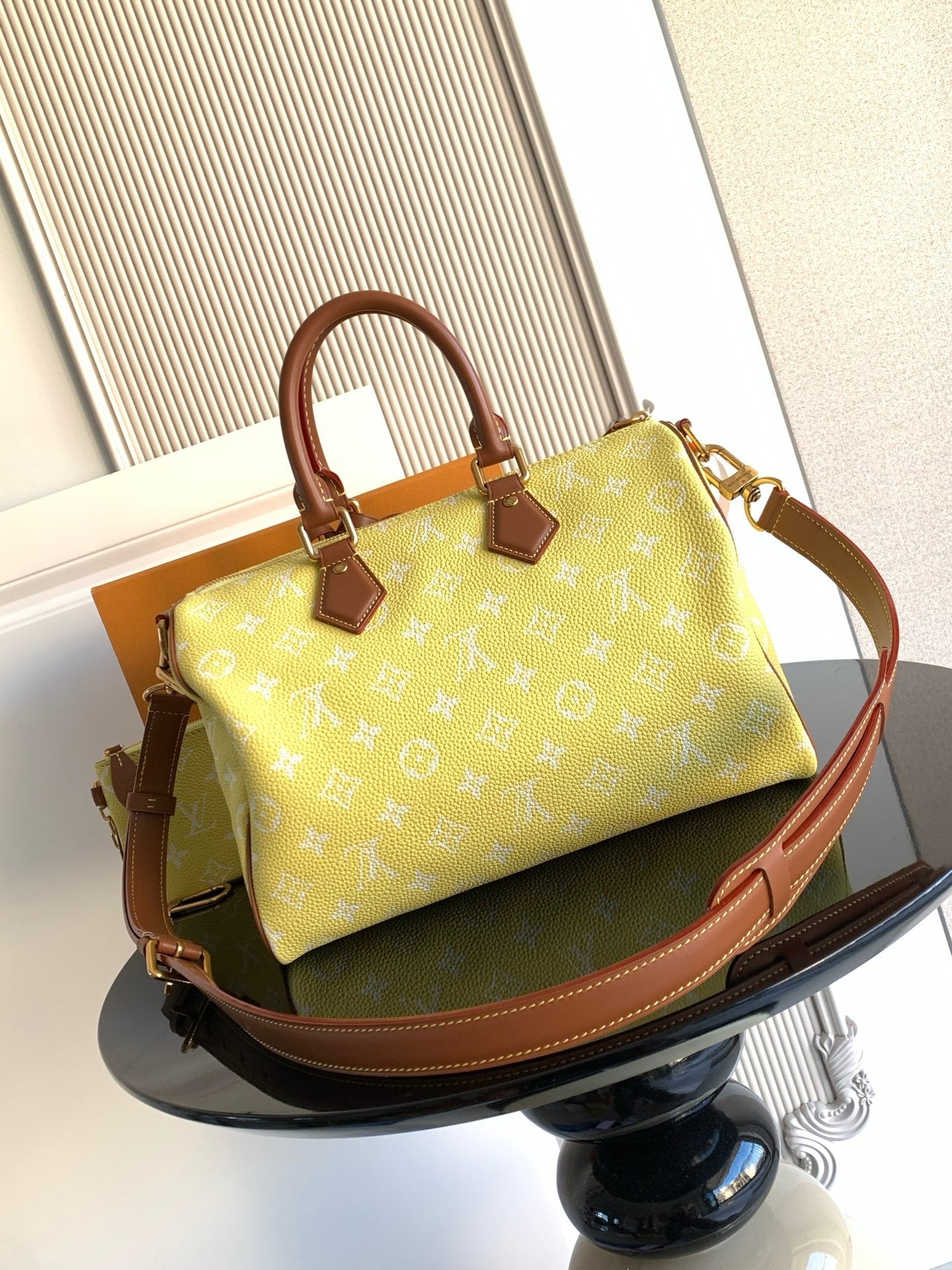 Louis Vuitton bag in yellow monogram with brown leather handles and shoulder strap