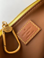 Louis Vuitton bag interior pocket with gold zipper pull and brown leather card holder