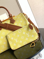 Louis Vuitton bag with yellow monogram and brown trim, plus crossbody strap and buckle