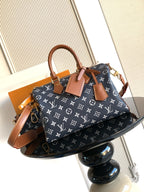 Louis Vuitton handbag in navy monogram canvas with tan leather trim and gold hardware