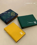 Small Louis Vuitton card holders, navy, green, and yellow, with embossed logo marks