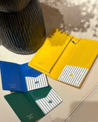 Small Louis Vuitton card holder, yellow, open view with metal clasp and interior slots