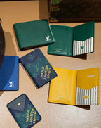Small Louis Vuitton card holders, green, teal, blue monogram, navy, and yellow
