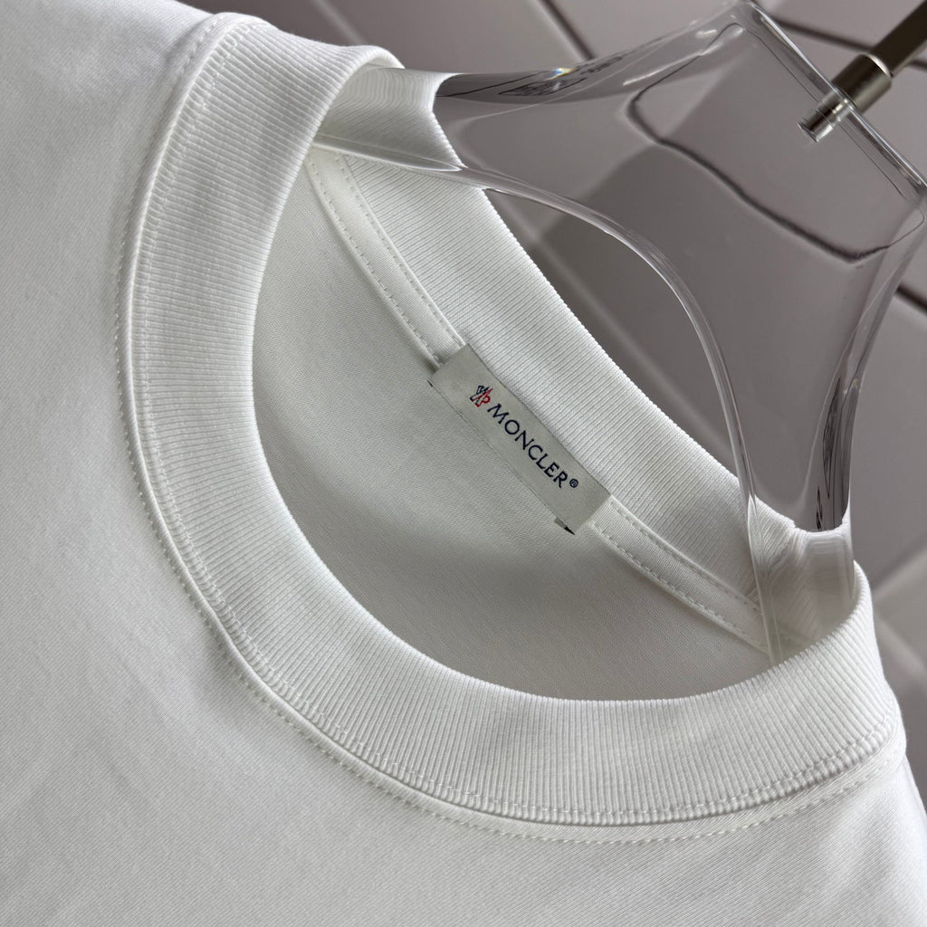 Moncler white crewneck T-shirt neckline with inner brand label, close-up