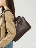 MiuMiu leather tote bag in dark brown, side view with gold hardware and top handles
