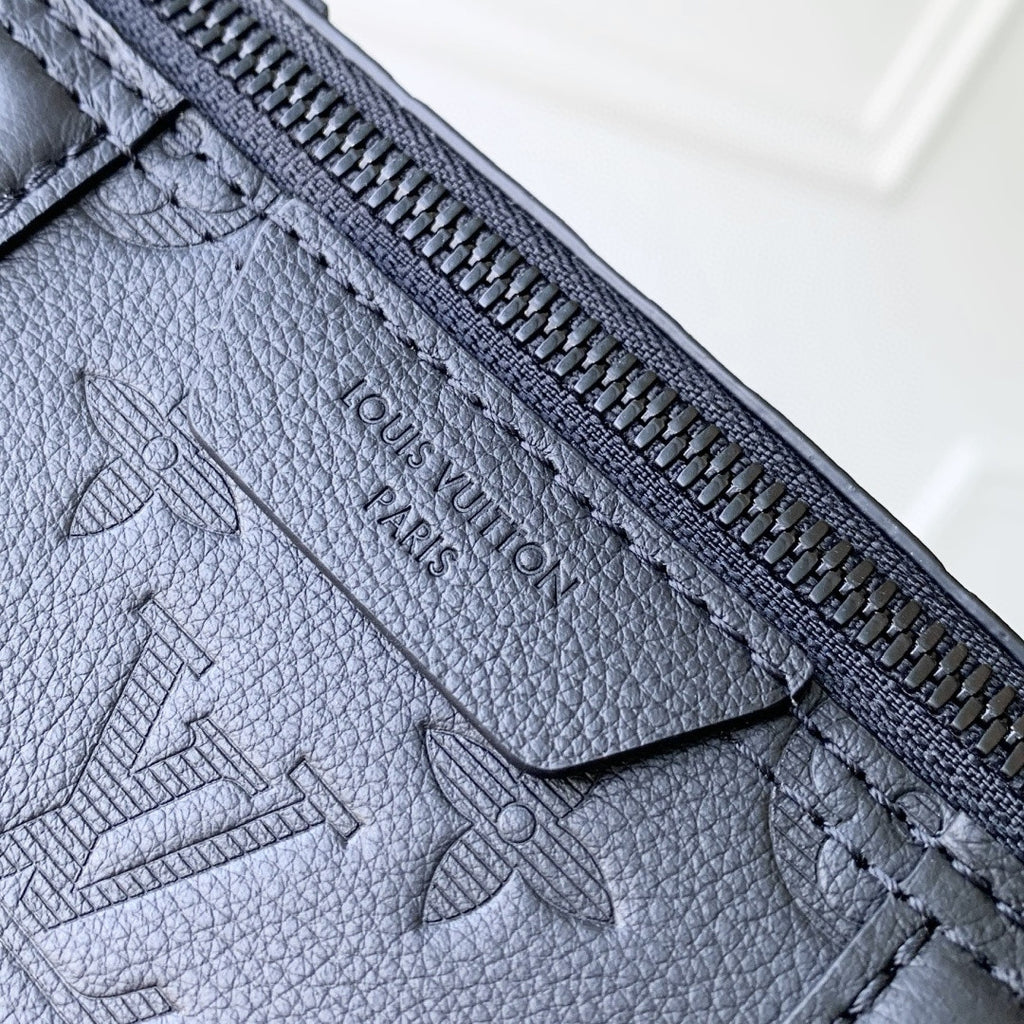 Louis Vuitton zipper edge and embossed logo on dark blue monogram leather