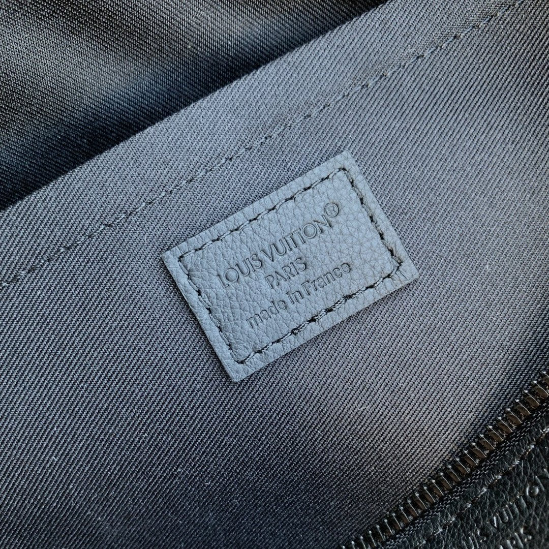 Louis Vuitton label on dark blue interior lining of monogram bag