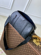 Louis Vuitton men’s crossbody bag with dark blue monogram panel and gold clasp