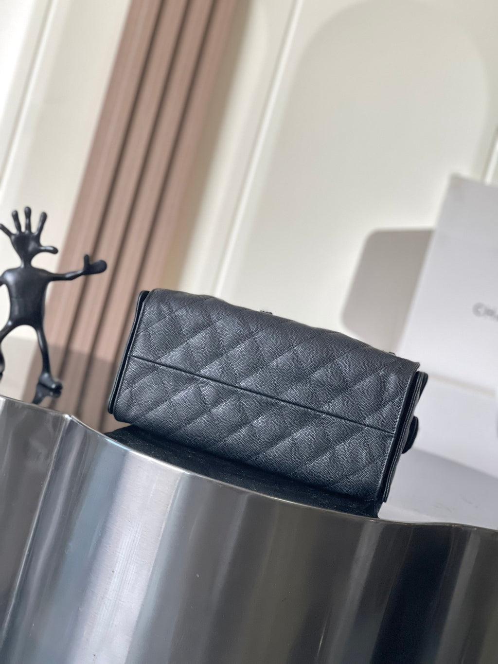 Chanel quilted flap bag with chain strap, structured rectangular shape, dark