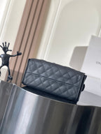 Chanel quilted flap bag with chain strap, structured rectangular shape, dark