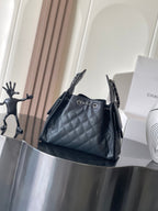 Chanel quilted shoulder bag with chain strap and back pocket, dark
