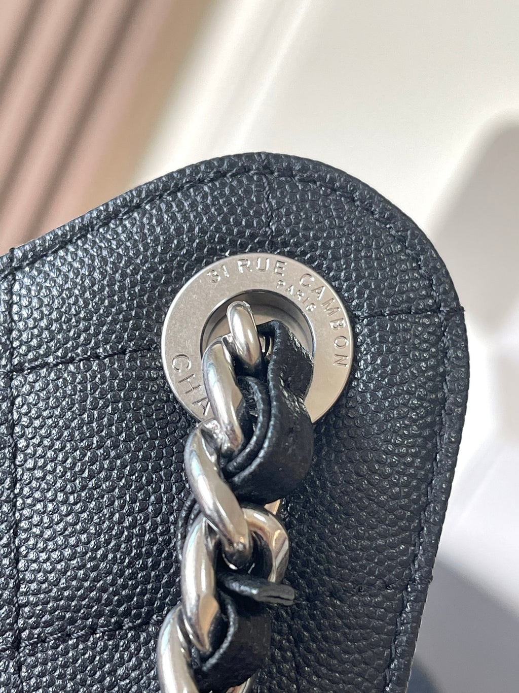 Chanel chain bag clasp with metal ring and logo medallion, dark leather