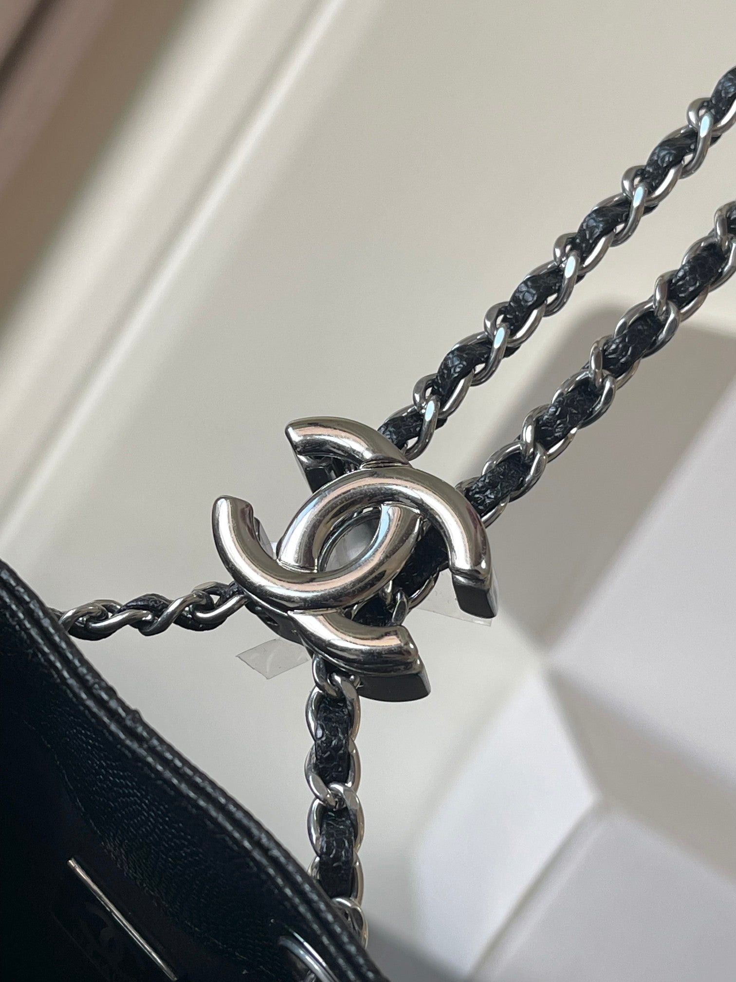 Chanel chain strap connector with metal O-ring hardware, dark bag