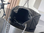 Chanel quilted bag with chain strap, open top showing dark fabric lining