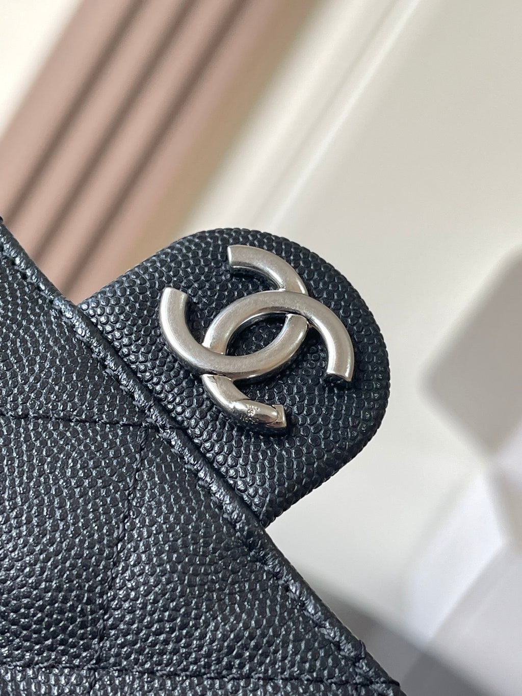 Chanel quilted bag snap hook detail with dark leather texture
