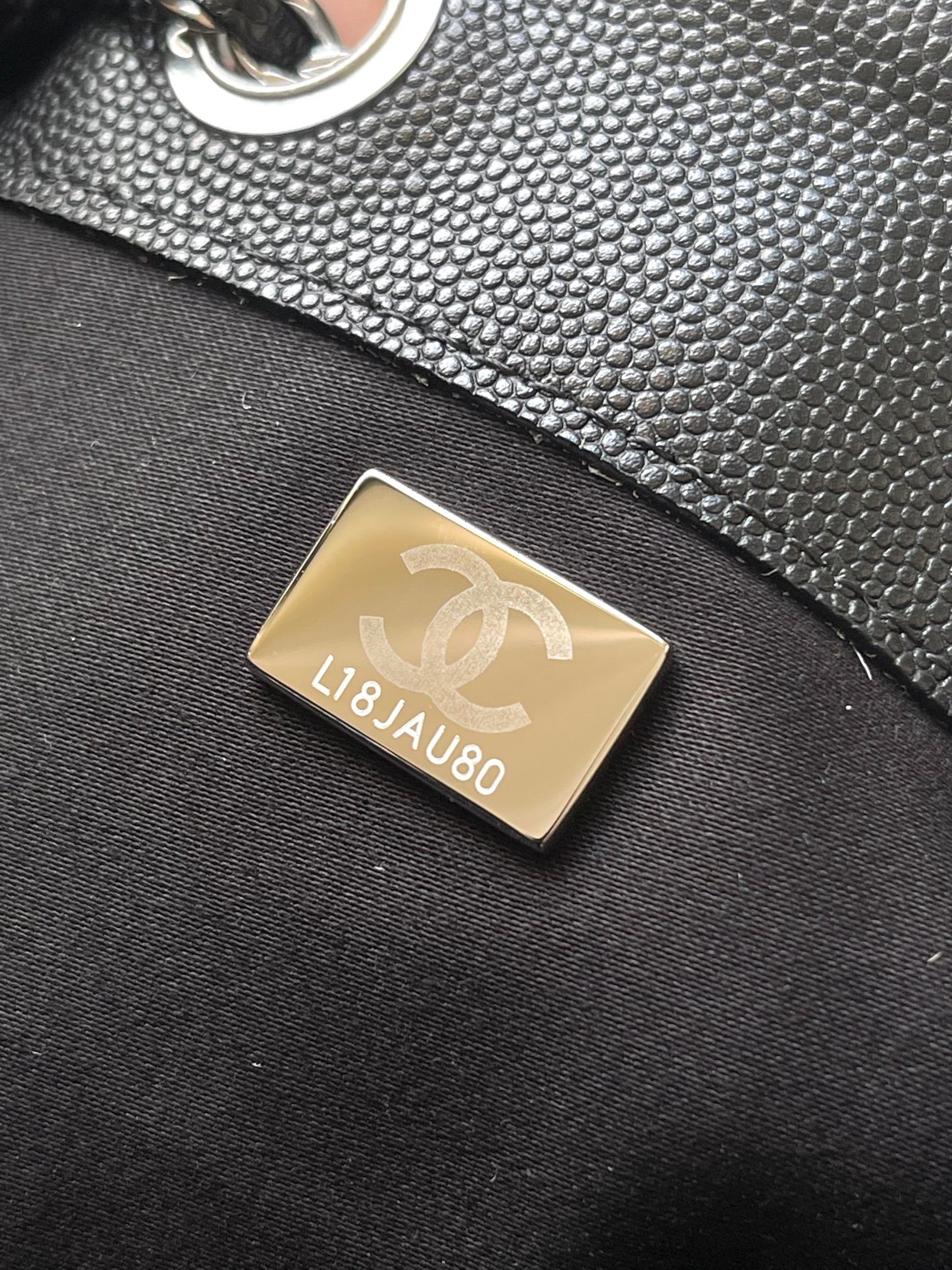 Chanel bag interior label with gold-toned plate, embossed lettering