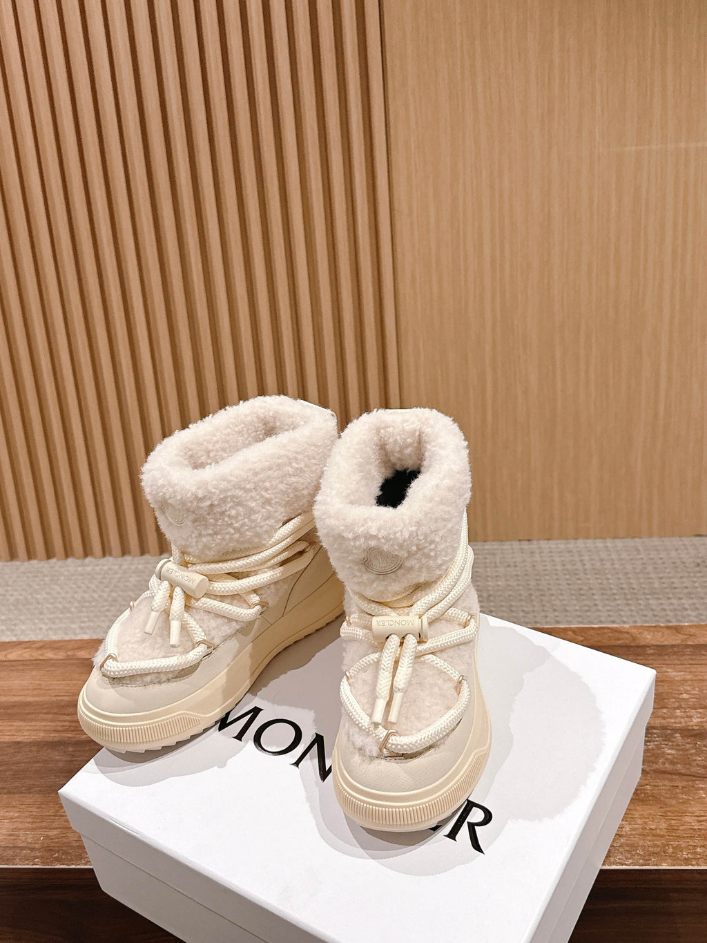 Moncler cream shearling lace-up boots with side logo crest