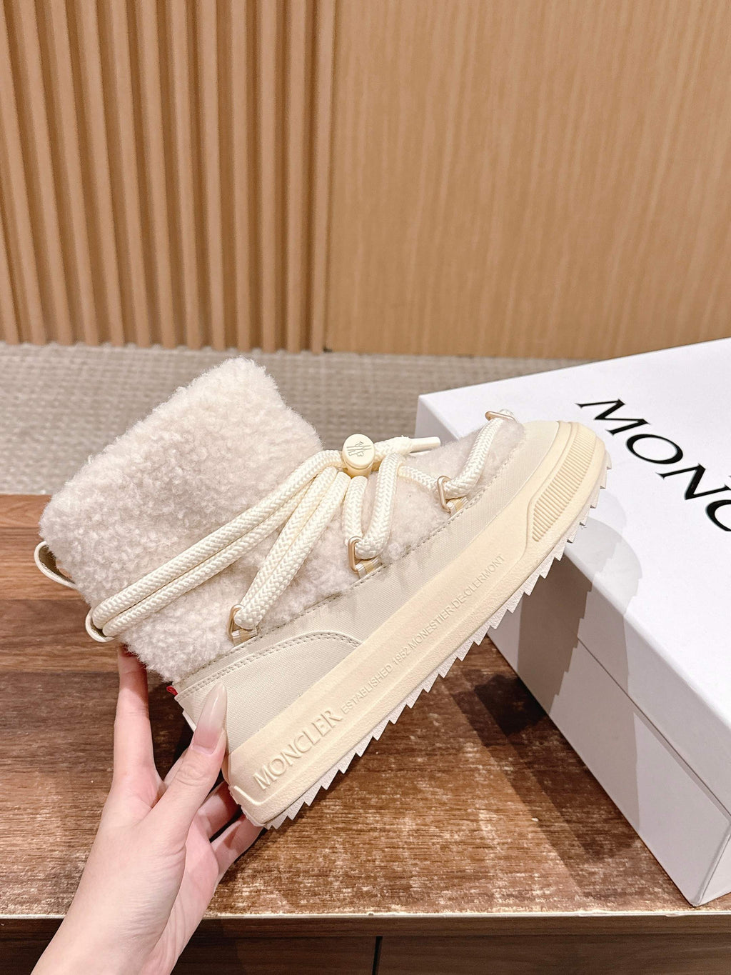 Moncler cream shearling lace-up boot, side view with lace tips