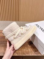 Moncler cream shearling lace-up boot, side view with lace tips