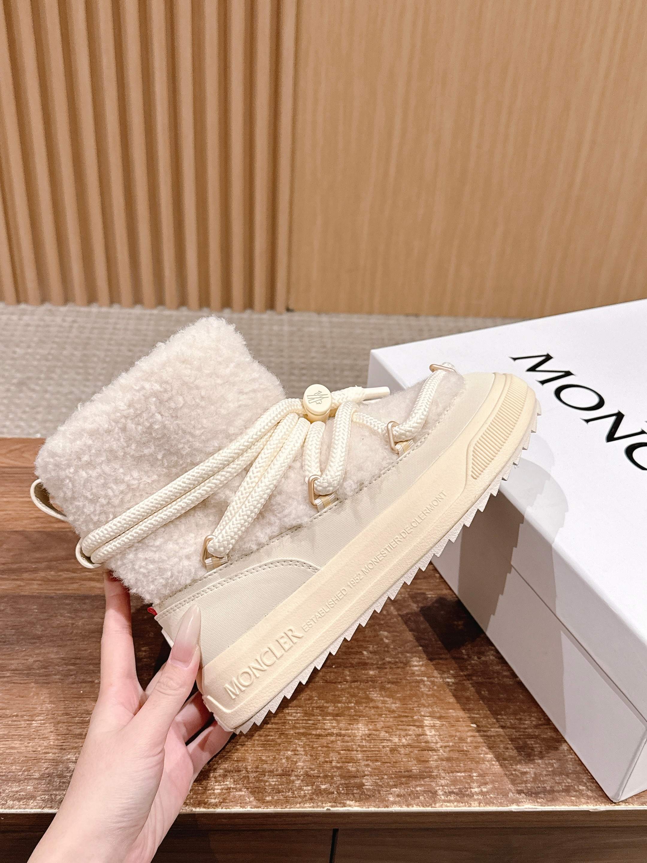 Moncler cream shearling lace-up boot, side view with lace tips