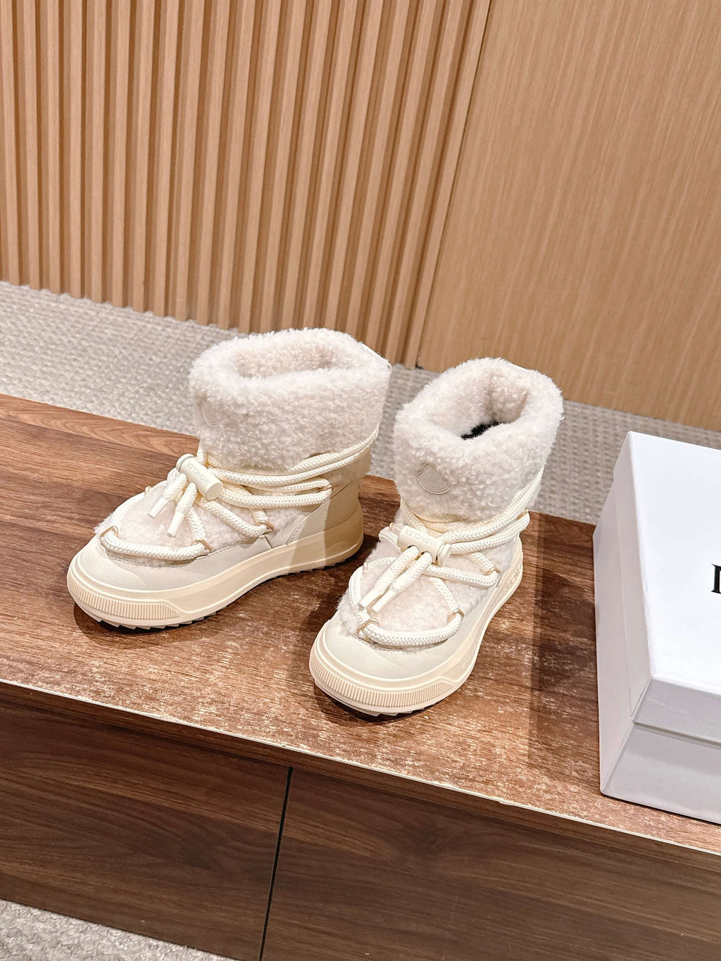 Moncler lace-up shearling boots in cream, pair side view