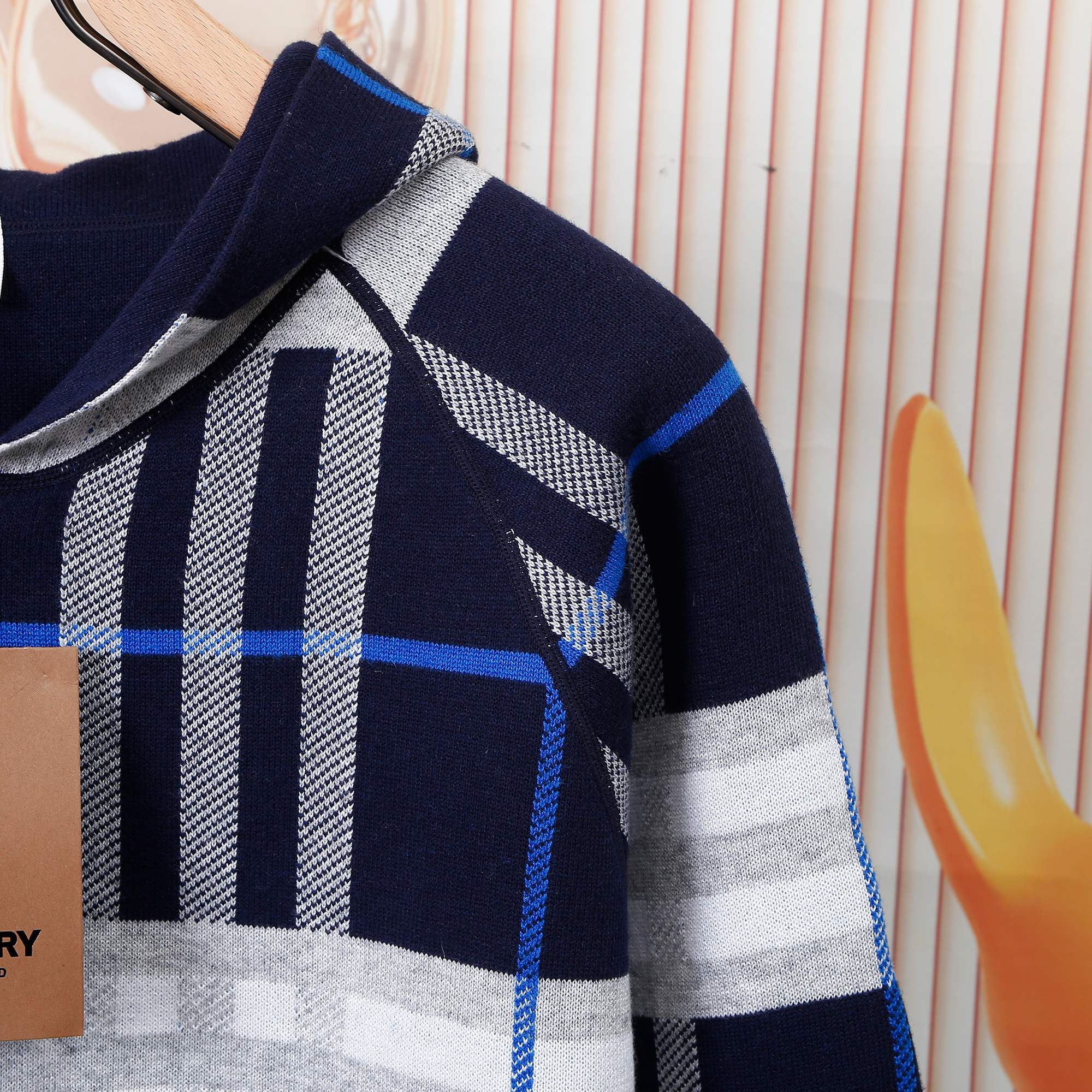 Children's navy plaid hoodie sleeve with white and blue stripe panel detail