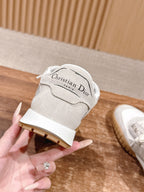 White sneaker heel strap with “Christian Dior” logo and gum sole