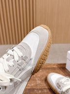 Close-up of white lace-up sneaker side and gum rubber outsole