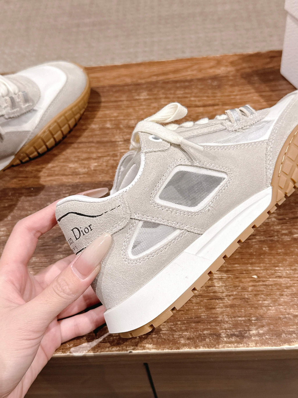 White lace-up sneaker with gum sole and small Dior heel label