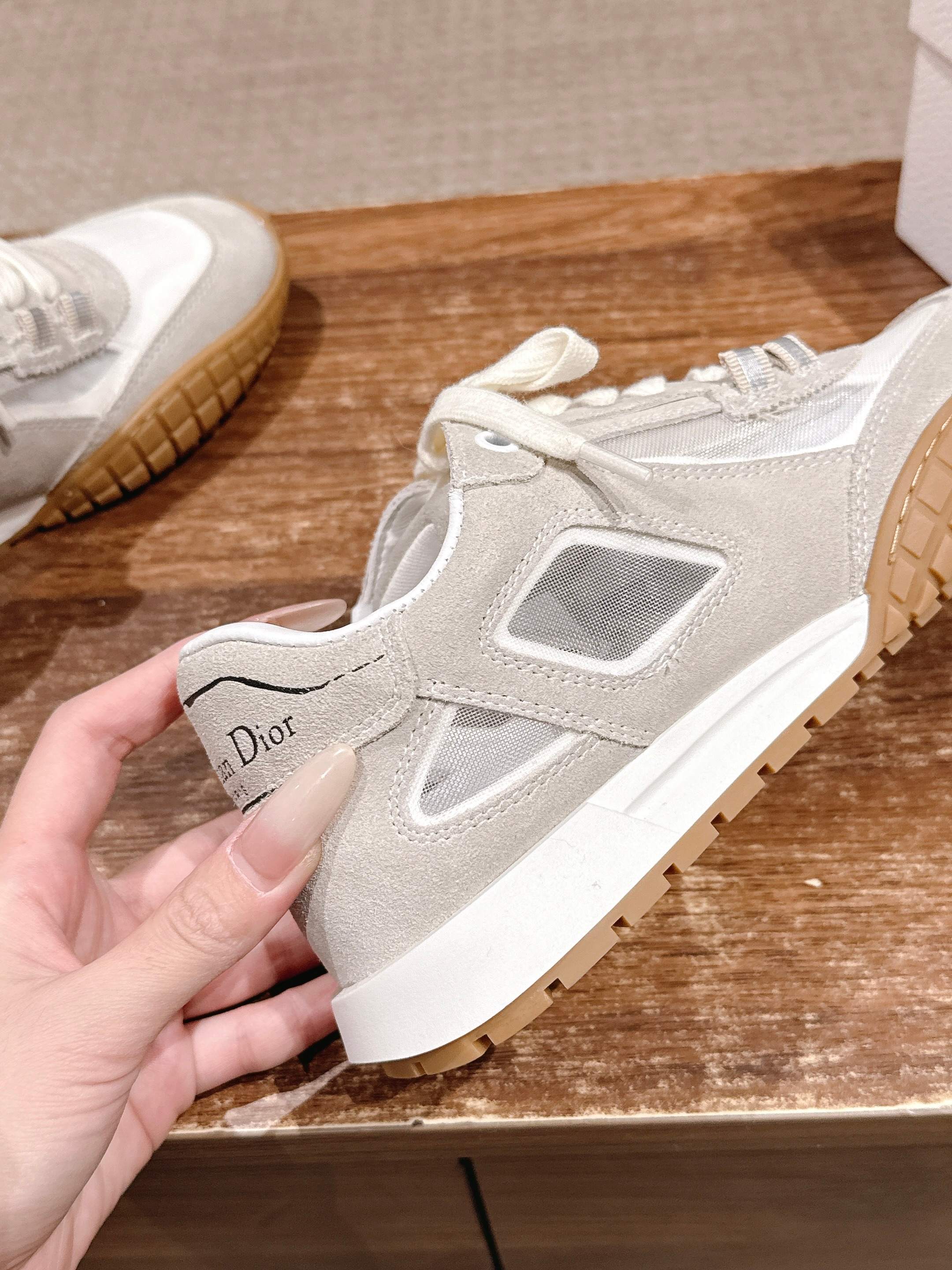 White lace-up sneaker with gum sole and small Dior heel label