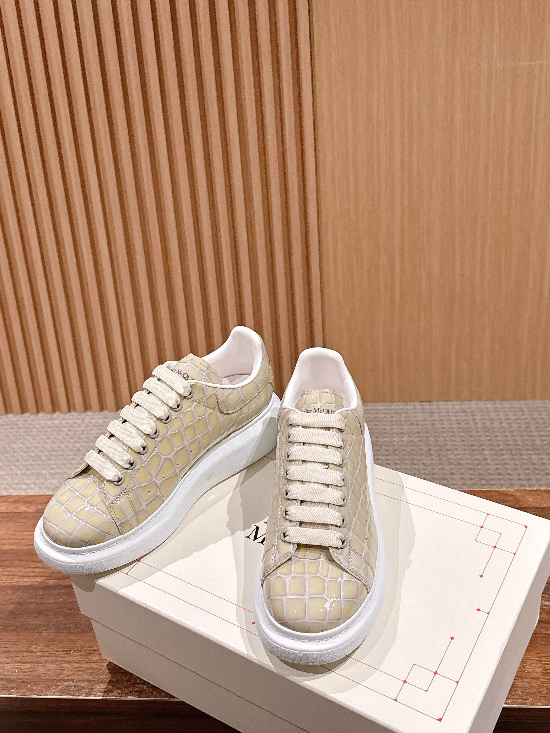 Cream alligator-embossed leather sneakers with white lace-up style and sole