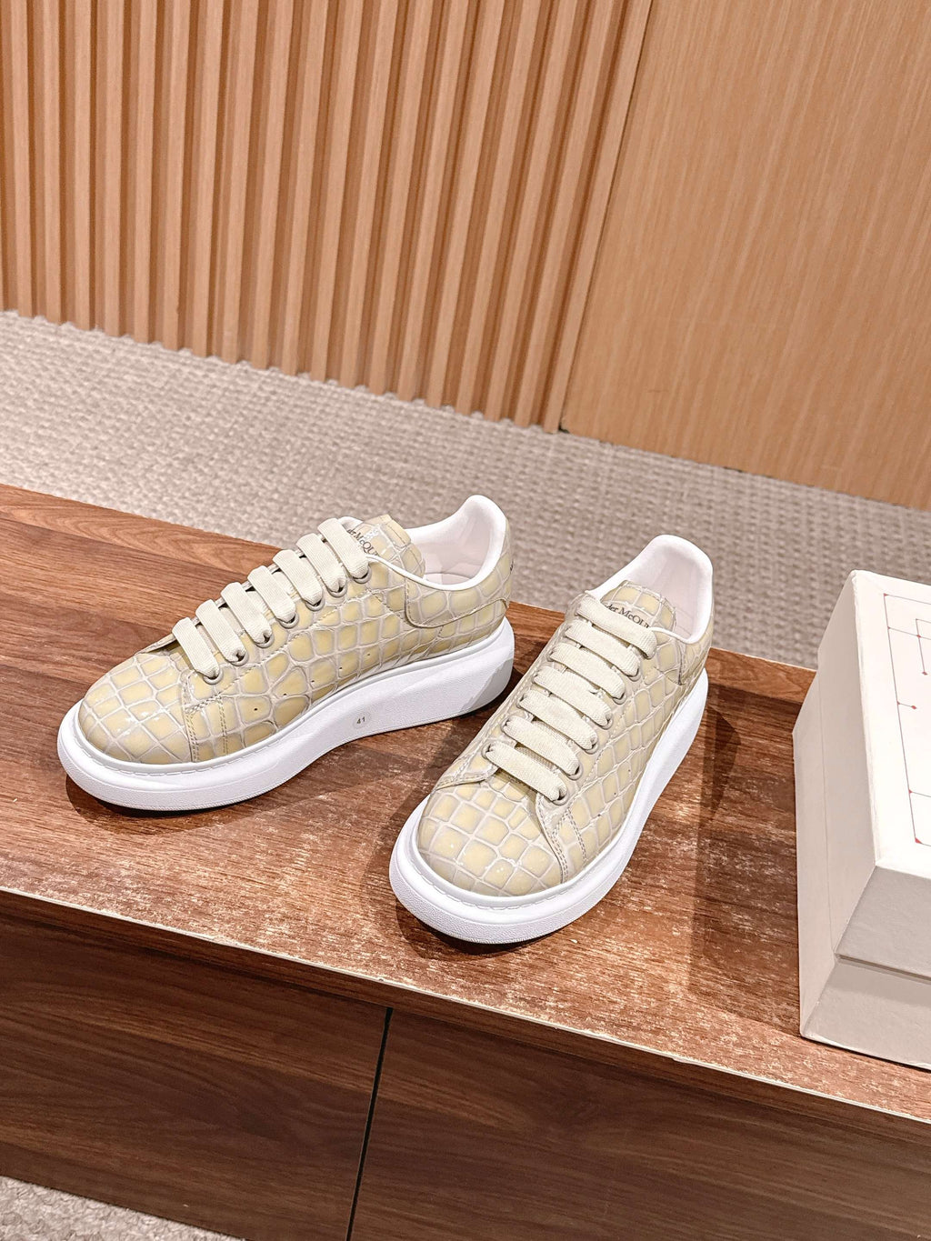 Pair of cream alligator-embossed leather sneakers with white rubber soles