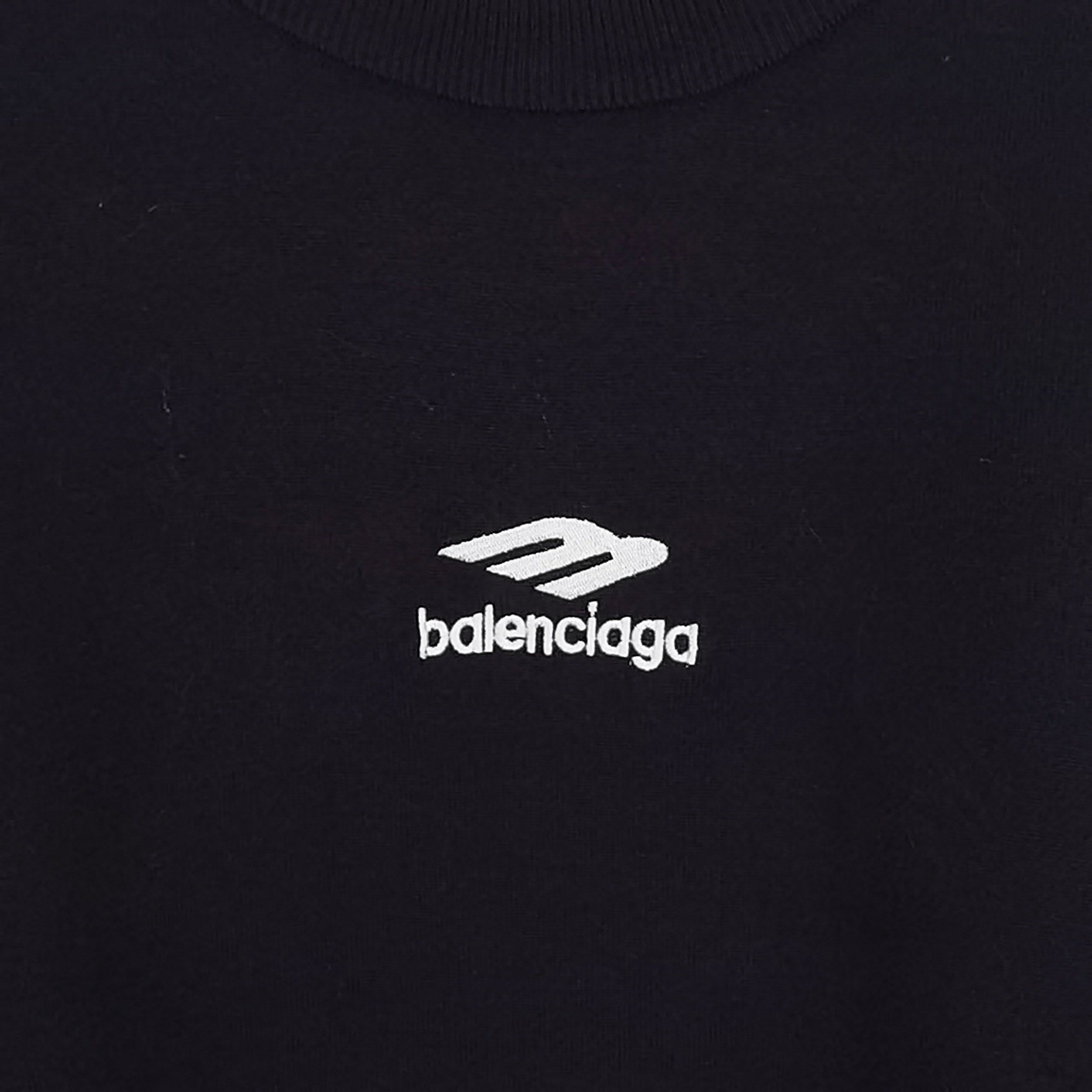 Balenciaga logo patch on dark crewneck sweater, close-up
