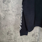 Balenciaga dark sweater sleeve detail with repeating balenciaga logo print