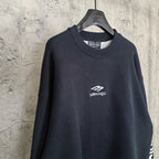 Balenciaga dark crewneck sweater, front view with centered logo on chest