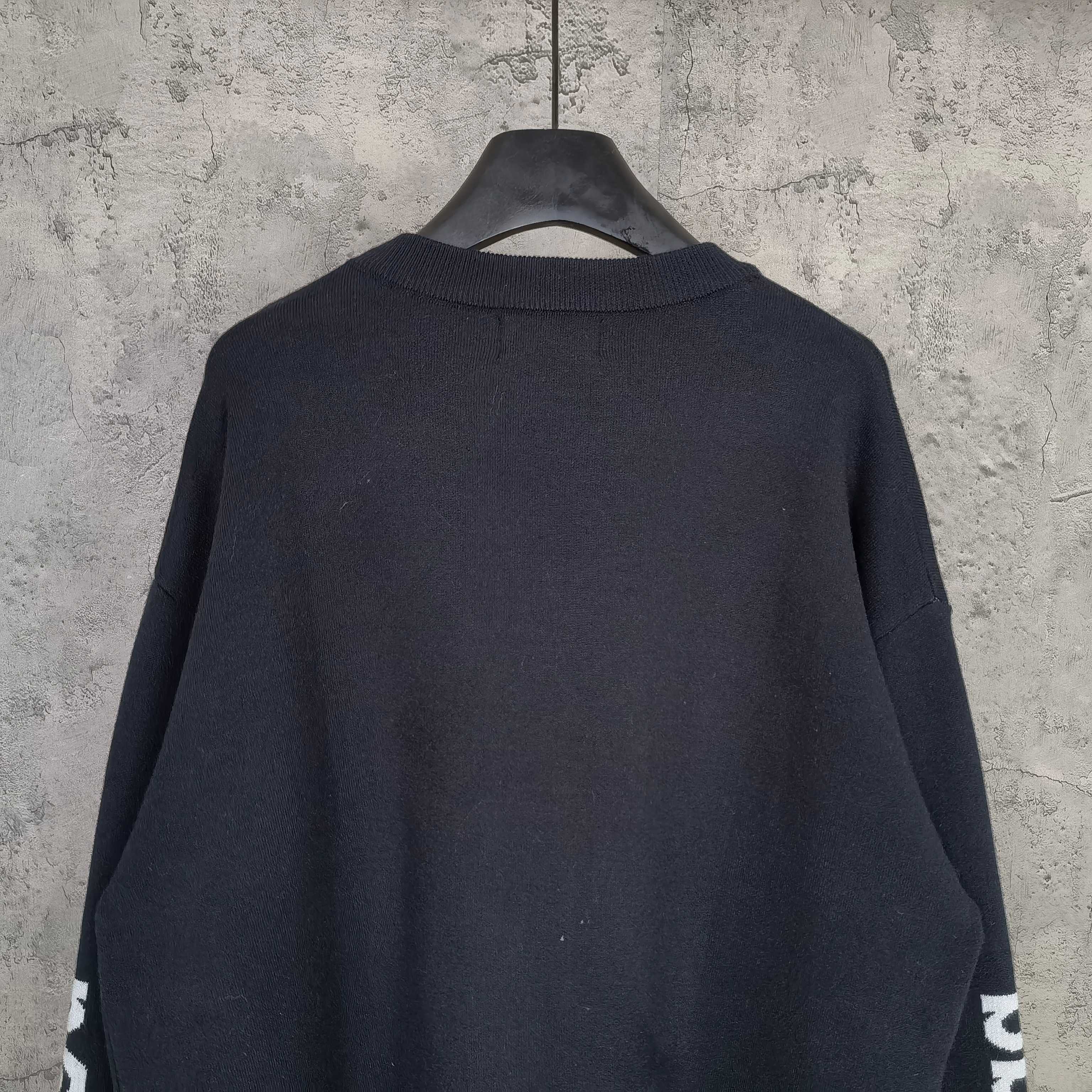 Balenciaga dark crewneck sweater, back view with ribbed hem and cuffs