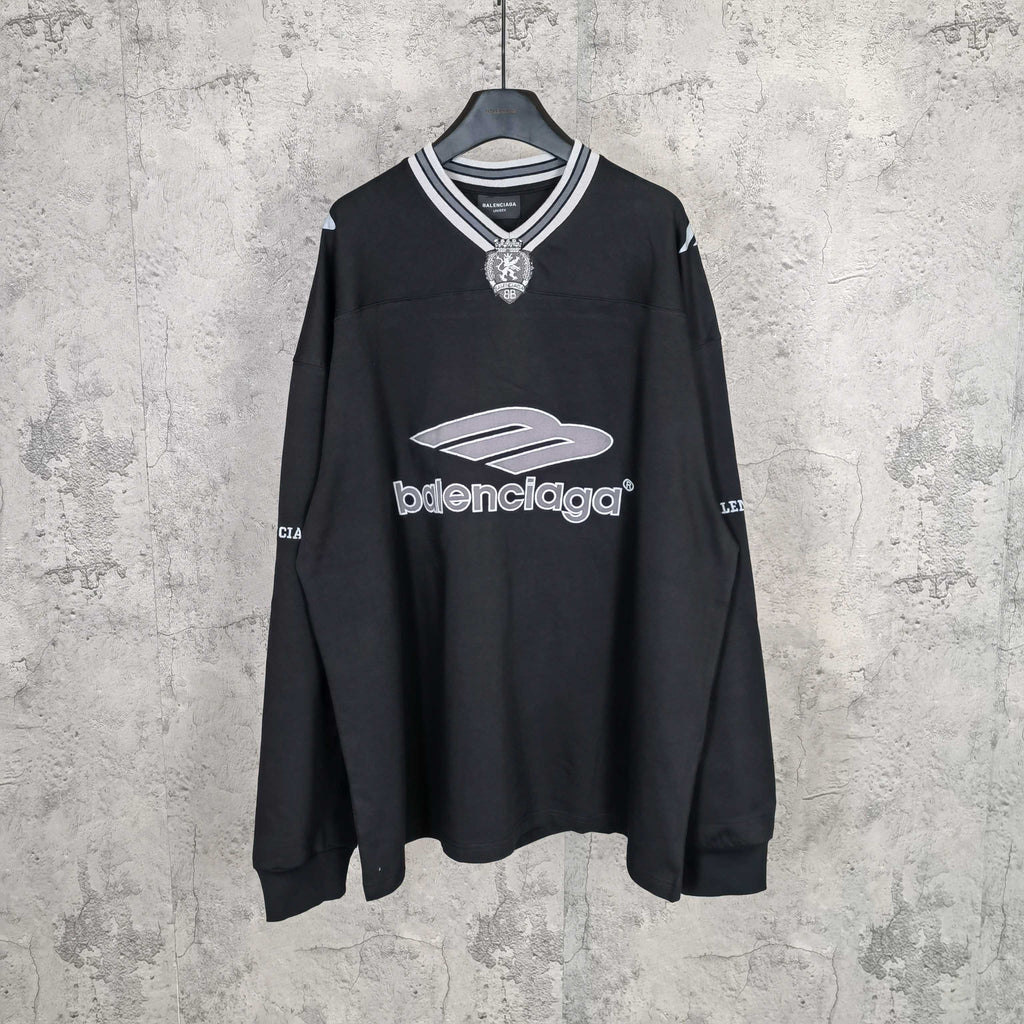 Black long-sleeve V-neck shirt with striped collar and Balenciaga front logo print.