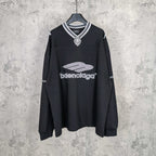 Black long-sleeve V-neck shirt with striped collar and Balenciaga front logo print.