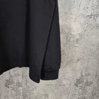 Black long-sleeve shirt with curved hem and plain sleeve