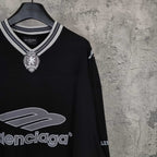 Black long-sleeve shirt with crest emblem and Balenciaga logo at neckline