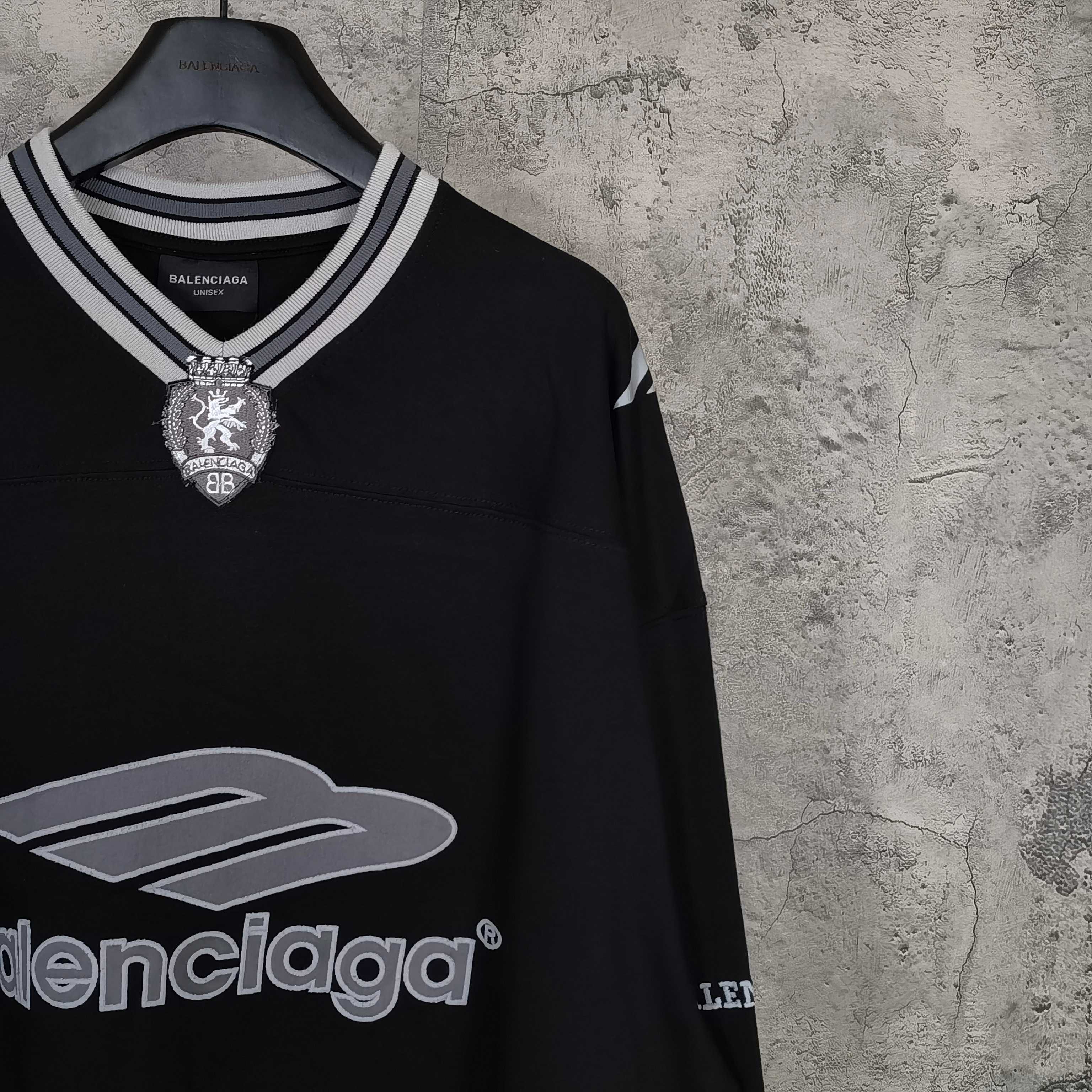 Black long-sleeve shirt with crest emblem and Balenciaga logo at neckline