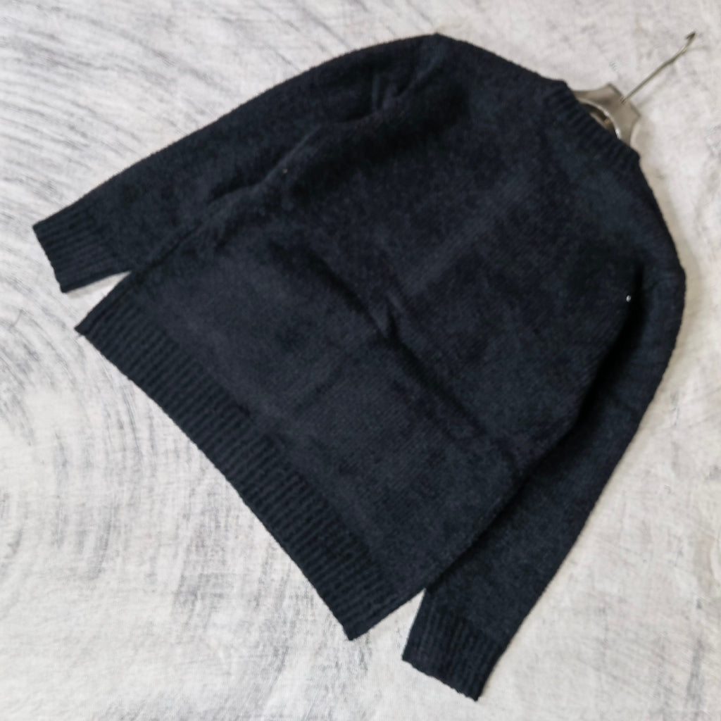 Louis Vuitton dark knit cardigan laid flat, textured knit and ribbed cuffs