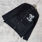 Louis Vuitton dark knit cardigan laid flat, button front and white LV logo