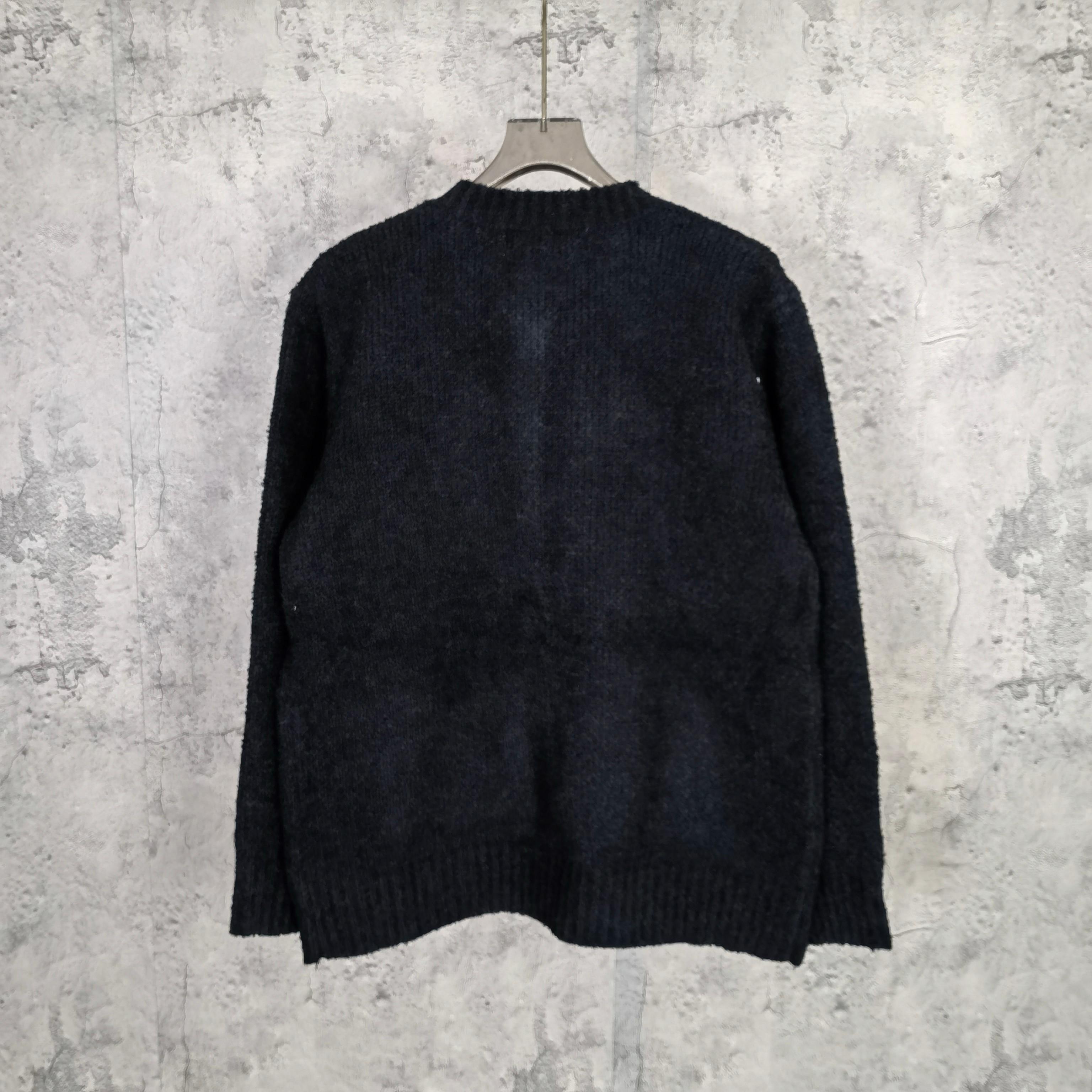 Louis Vuitton dark knit cardigan, back view with ribbed hem and cuffs