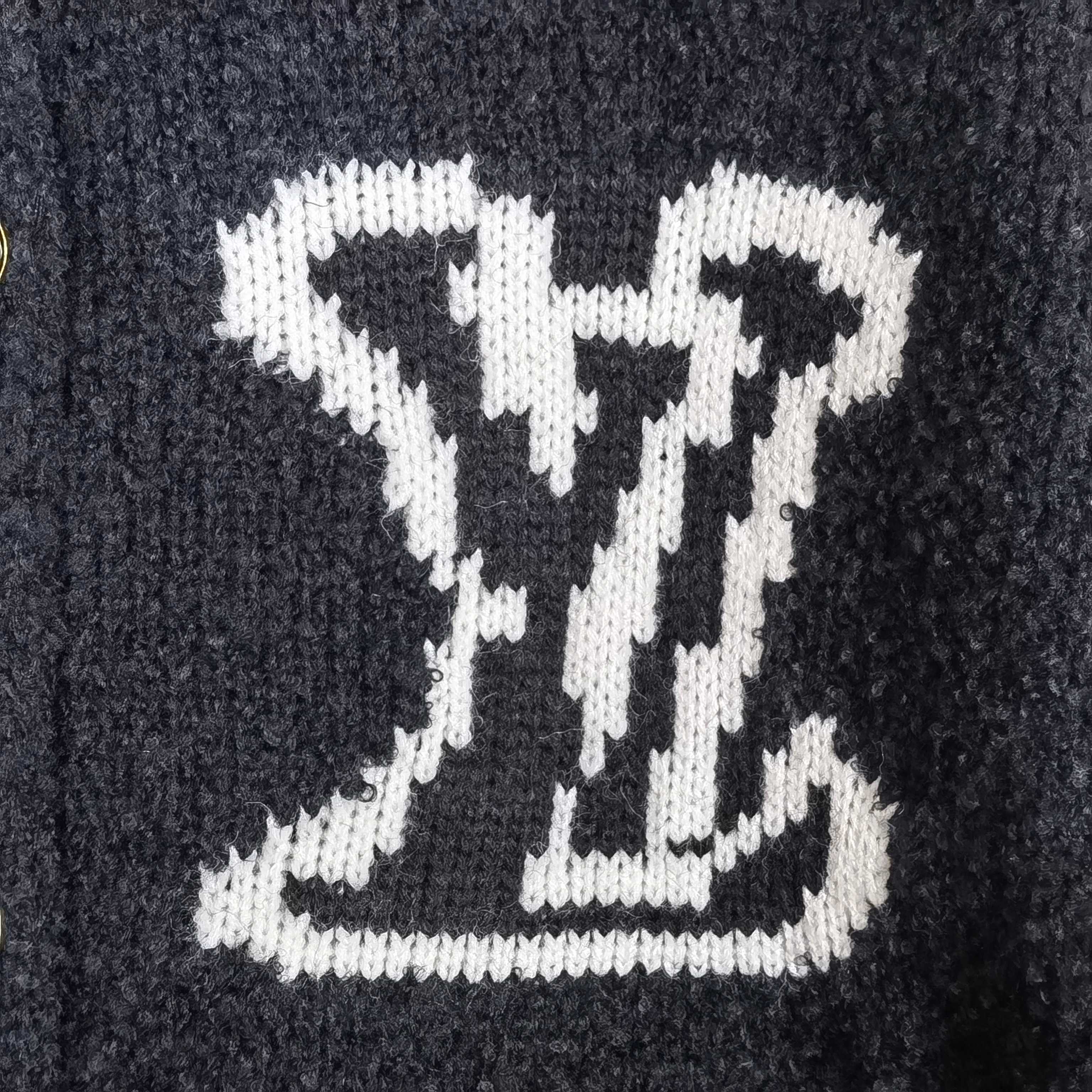 Louis Vuitton white LV monogram knit pattern on dark cardigan