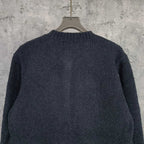 Louis Vuitton dark knit cardigan, back view with textured knit and ribbed hem