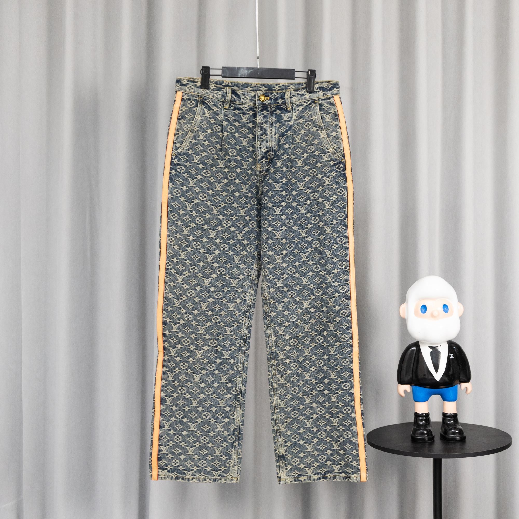 Louis Vuitton monogram denim pants with orange side stripe and front button closure
