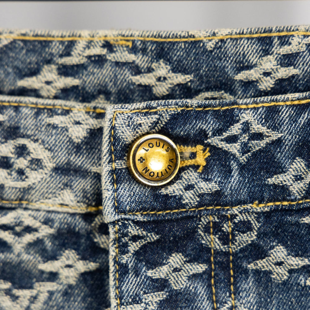 Louis Vuitton monogram denim pants close-up of gold button at waistband