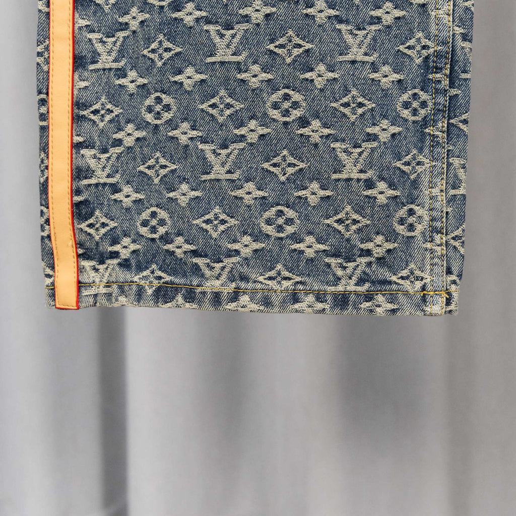 Louis Vuitton monogram denim pants pocket area with orange-trimmed edge
